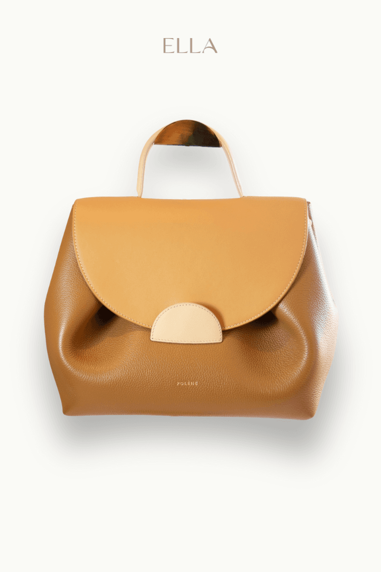 Hand holding black machined steel mechanical pencil with brass tip and top.