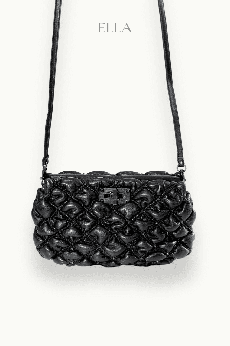 Hand holding black machined steel mechanical pencil with brass tip and top.