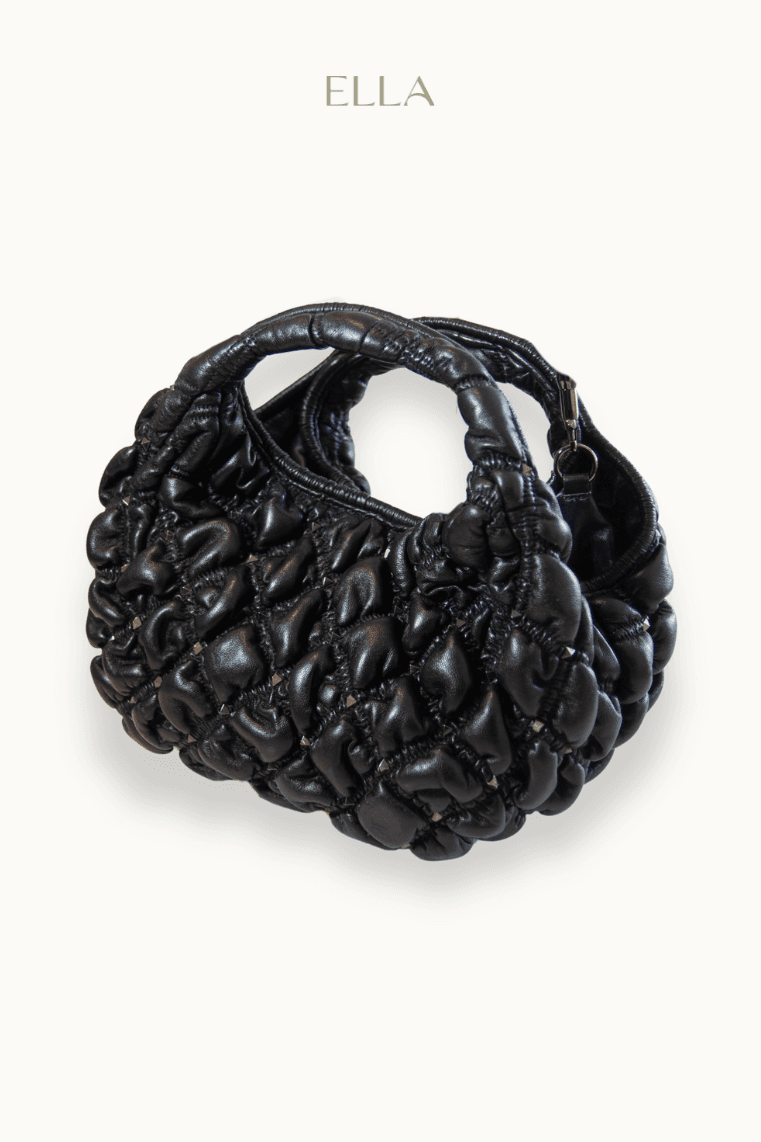 Hand holding black machined steel mechanical pencil with brass tip and top.