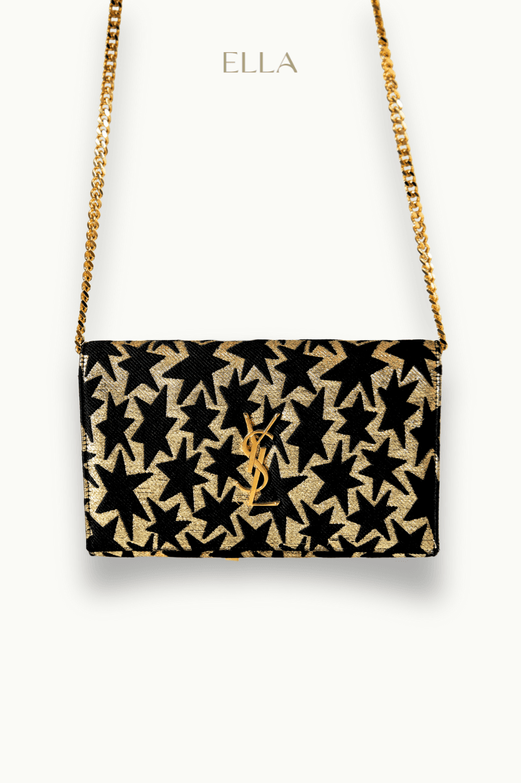 Hand holding black machined steel mechanical pencil with brass tip and top.