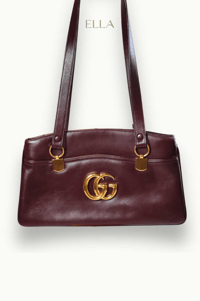 Hand holding black machined steel mechanical pencil with brass tip and top.