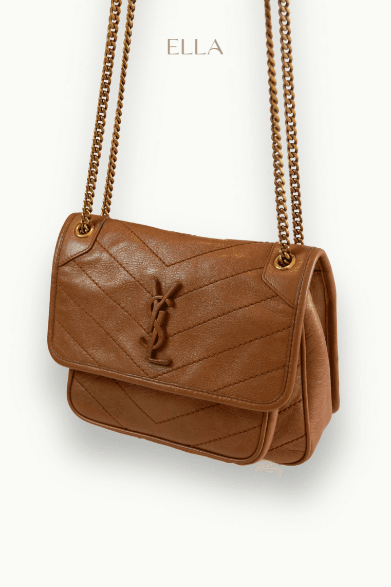 Hand holding black machined steel mechanical pencil with brass tip and top.